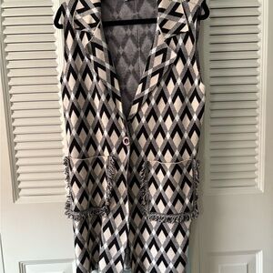 Very pretty jumper/vest with one button and two front pockets .Worn once. Sz Med